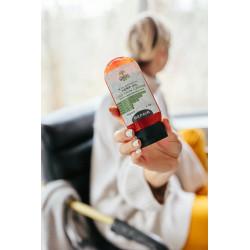 Person Holding Orange Plastic Bottle