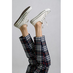 A Person Wearing Checkered Pants and White Sneaker Shoes