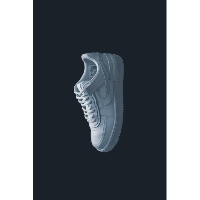 A Person Holding a Pair of Sneakers